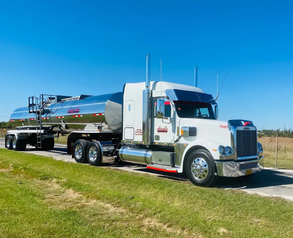 A white truck is parked on the side of the road.